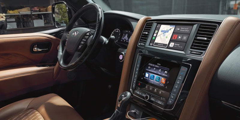 Infiniti SUV dashboard with navigation and touchscreen controls.