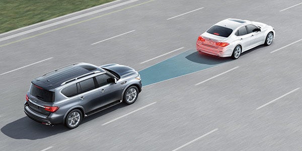 Infiniti SUV using adaptive cruise control on highway.